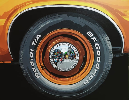Sujit Karmakar painting of a car tyre with a detailed urban street scene visible in the center with vehicles and pedestrians
